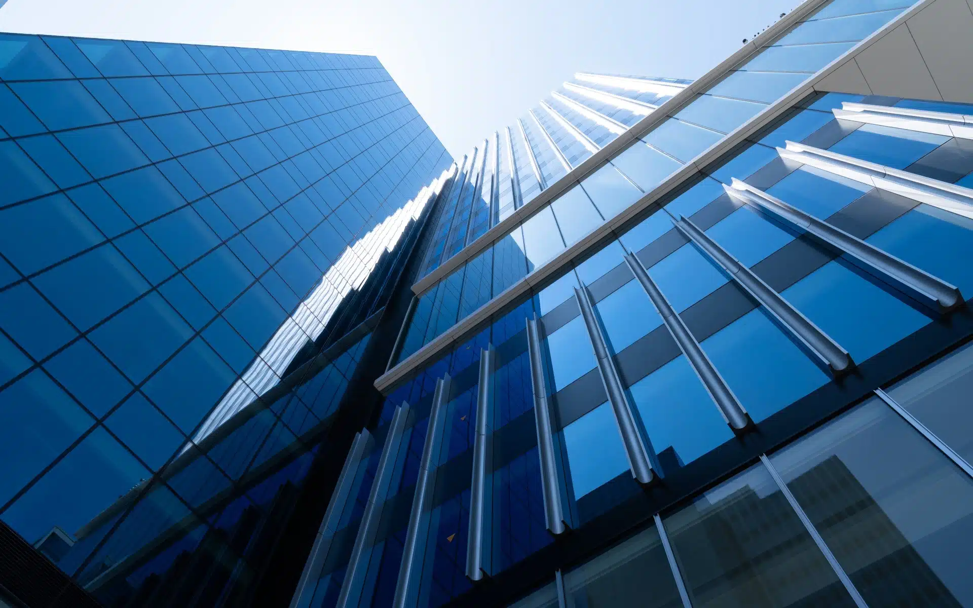 blue reflective building with a sky view